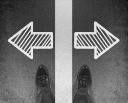 pair of foot standing on a floor with two arrows